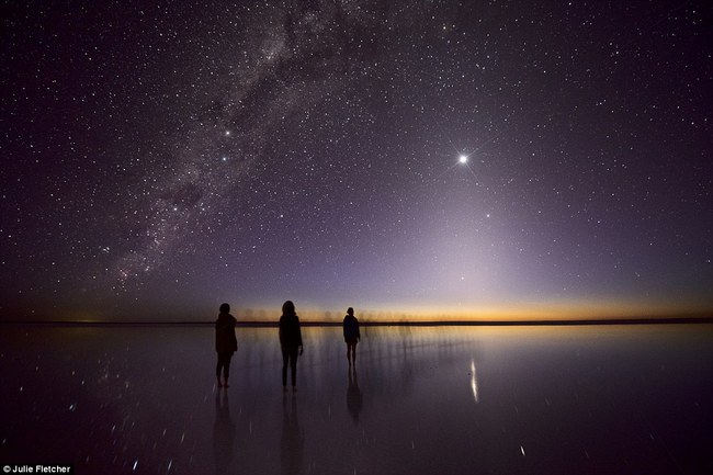  Night star dome above the horizon lined up the pyramid to the top - bright Venus glowing diamond. Enchanting picture-deep in surf the waters of the lake near the EIRIS Kati Thanda watching three women